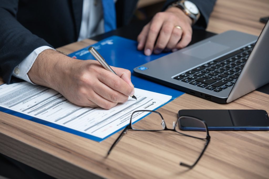 Solicitor filling out a form with a laptop