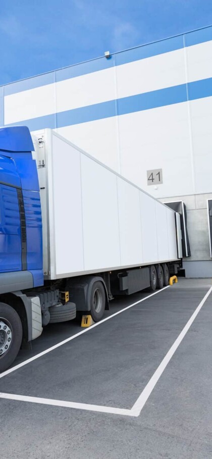 Blue Truck And Gates Of Big Distribution Warehouse