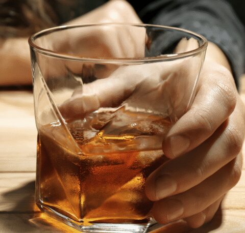 Person holding alcoholic drink
