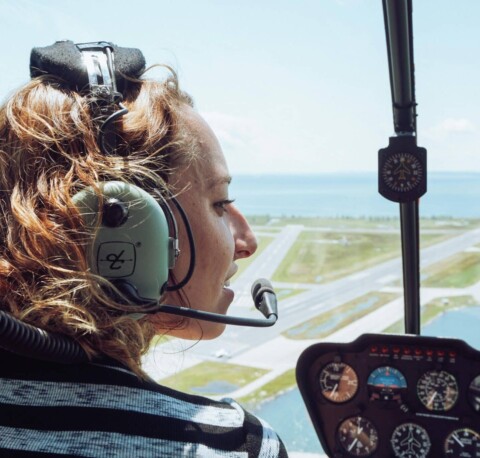Female helicopter pilot talking on mouthpiece